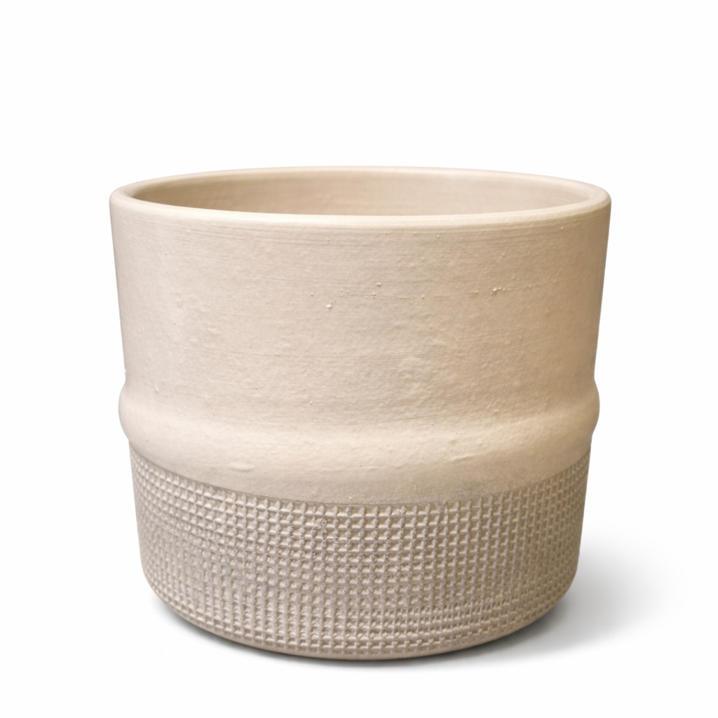 Beige ceramic planter with textured design on a white background